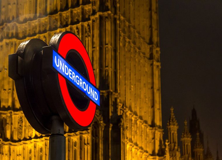 London Underground sign outside the gothic Palace of Westminster