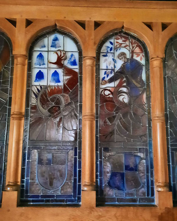 Window in Lyminster church showing dragon-slaying legend