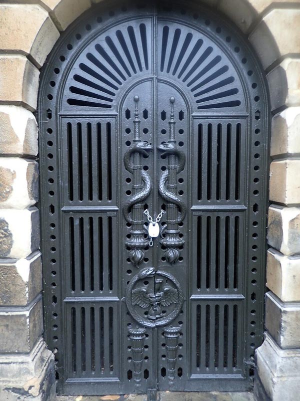 Ornate snake-entwined gates to Brompton Cemetery's catacombs