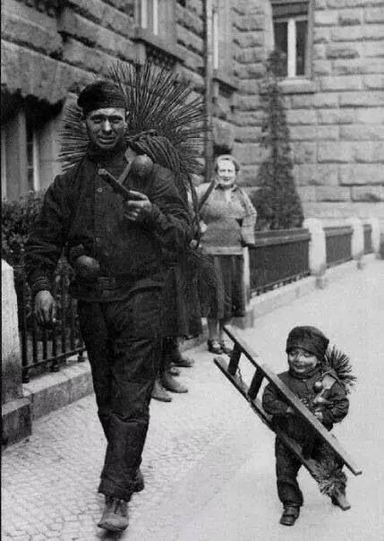 A chimney sweep with a tiny 'climbing boy'