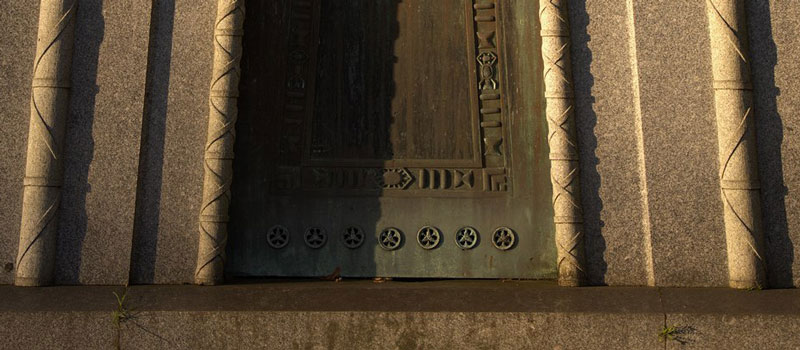 Close-up of wheel motifs on the door of the neo-Egyptian Courtoy tomb, Brompton Cemetery