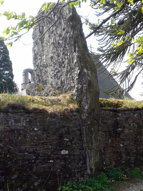 Standing stone in the wall of St John the Baptist's Churchyard, Ysbyty Cynfyn, Wales, Britain